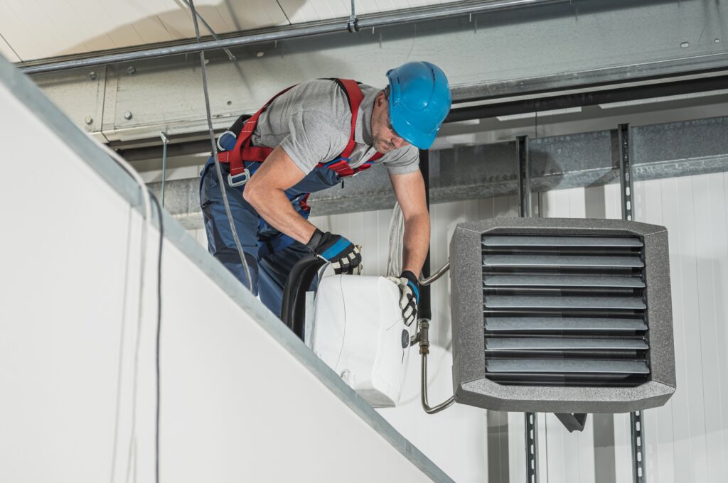 HVAC Technician Installing New Warehouse Air and Water Heaters