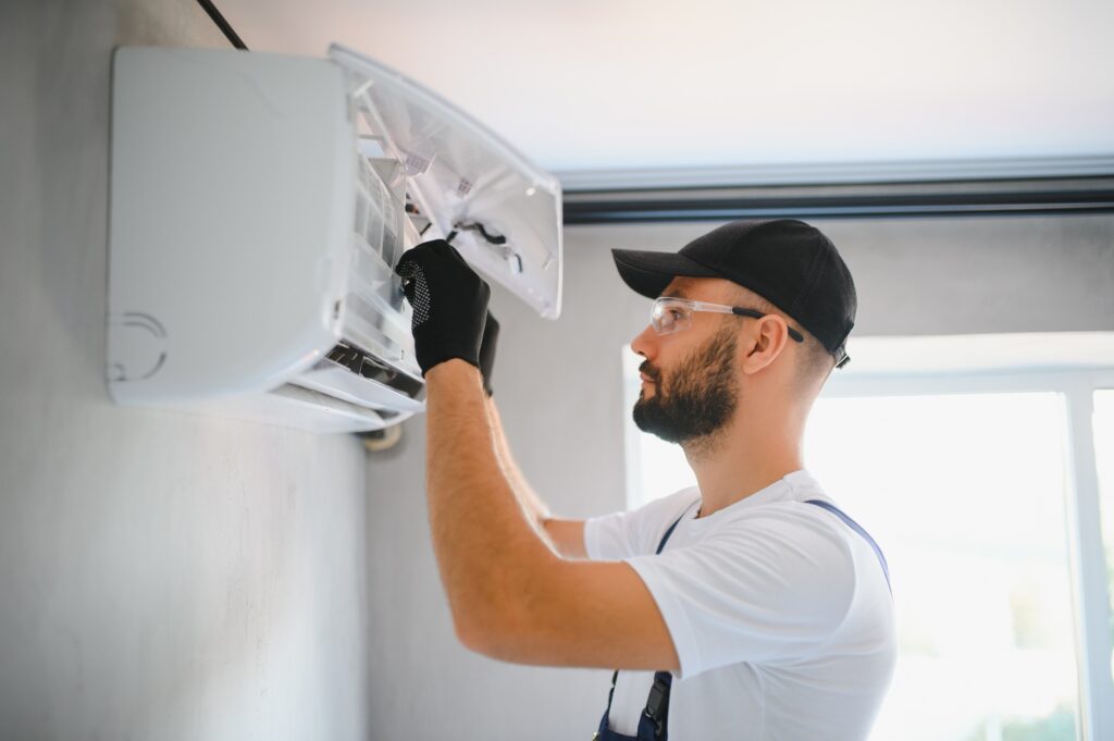 Male technicians service for repair and maintenance of air conditioners