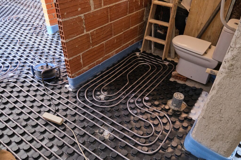 Radiant underfloor heating installation in a bathroom.