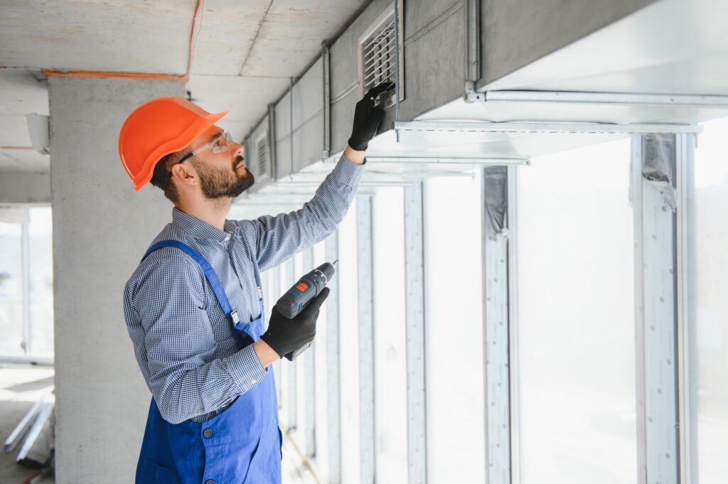 Warehouse Heating and Cooling System Installation by Professional Caucasian Technician