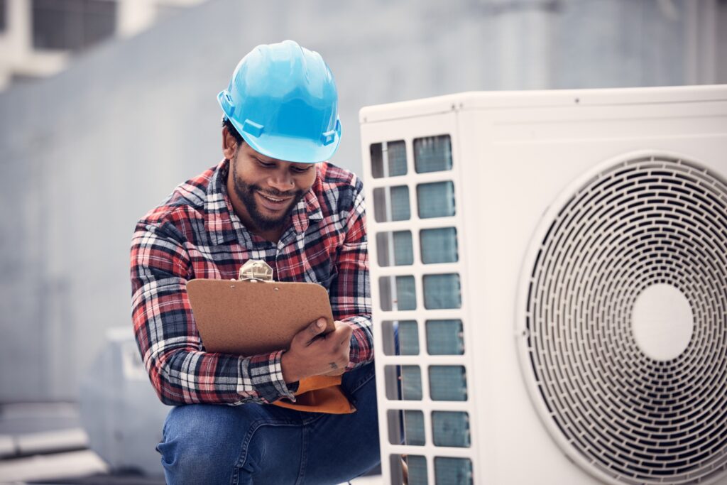 Air conditioner, clipboard and technician man inspection, maintenance and safety check for electric