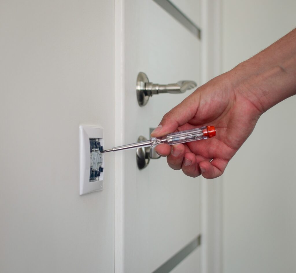 electrician repairing household socket, switch. electrical repair